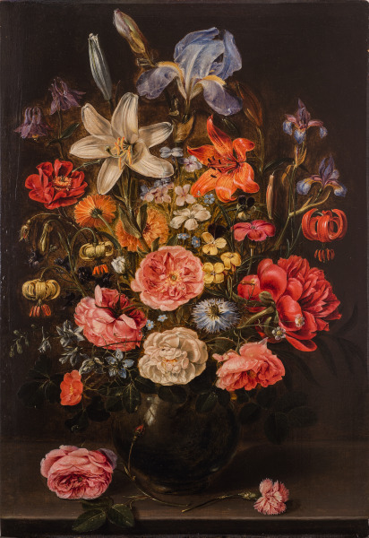 A STILL LIFE OF LILIES, ROSES, IRIS, PANSIES, COLUMBINE, LOVE-IN-A-MIST, LARKSPUR AND OTHER FLOWERS IN A GLASS VASE ON A TABLE TOP, FLANKED BY A ROSE AND A CARNATION