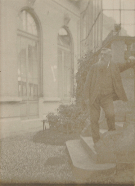 AUGUSTE RODIN STANDING ON STEPS