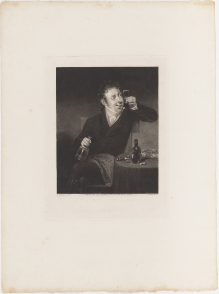 Man at Table Holding Glass of Wine to Light