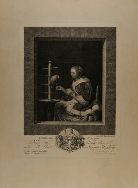 A YOUNG WOMAN FEEDING A PARROT