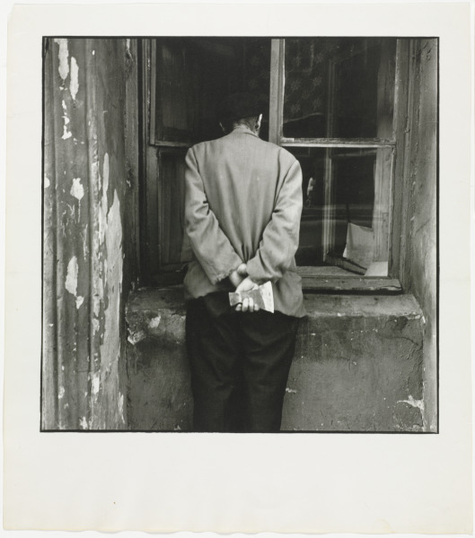 MAN PEERING IN SHOP WINDOW, ST. PETERSBURG