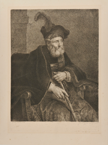 MAN WITH BEARD WEARING CLOAK AND FEATHERED HAT SEATED WITH A CANE IN HIS HAND