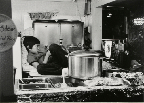 BOY IN KITCHEN WATCHING TV
