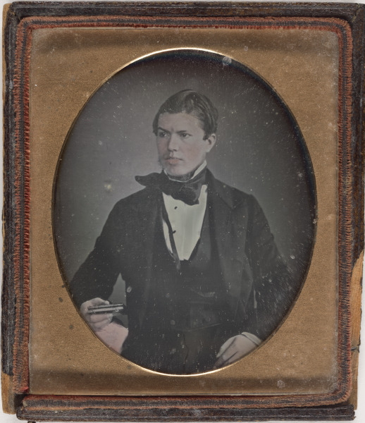 MAN HOLDING DAGUERREOTYPE