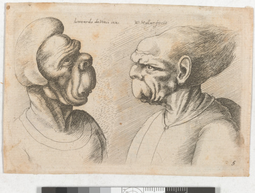 TWO DEFORMED HEADS FACING INWARDS