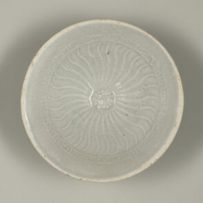 Bowl with Molded Flower at Center and Wavy Lines on Inside