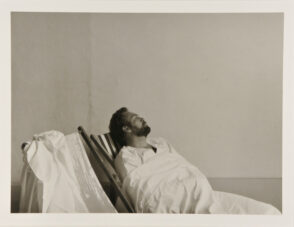 Figure Seated in Striped Lawn Chair