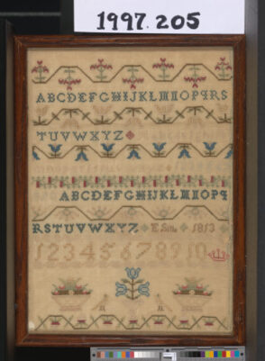 Band sampler with alphabets, floral baskets, etc.