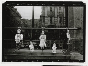 Dolls Hanging on Fence
