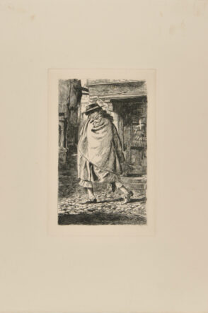 Man with Cloak and Flat Hat Walking Through a Street